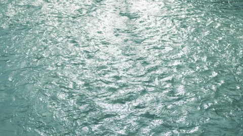 Charming view of a shallow body of rippled water flowing slowly, lit by sunrays Stock Footage 256140824