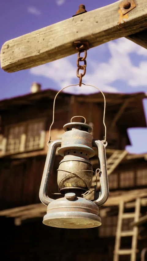 Charming vintage lantern swinging gently under the bright blue sky Stock Footage 341419602