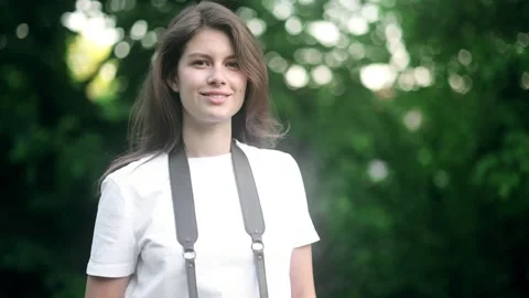 Charming Woman with camera in the park. Creative professional female Stock Footage 244591838