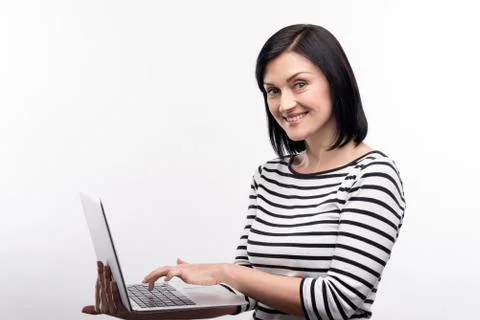 Charming woman posing while working on laptop Stock Photos