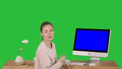 Charming woman presenting something on the screen of computer talking to camera Stock-Footage 113802340