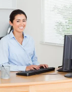 Charming woman working on a computer while sitting Foto stock