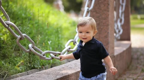 Charming year-old boy in the park knows the world. Stock Footage 66428568
