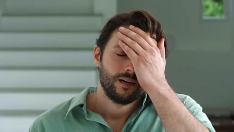 Charming young bearded dark-haired Caucasian man feels shocked by what he saw Stock Footage 213255427