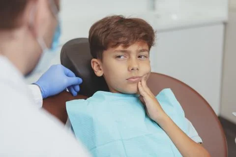 Charming young boy getting teeth checkup at the dentist Stock Photos