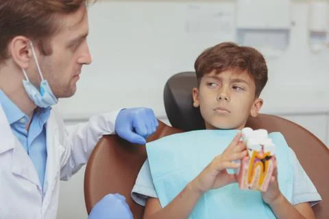 Charming young boy getting teeth checkup at the dentist Stock Photos