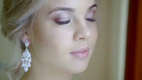 Charming young bride is looking in windows, standing in room, turning her head Stock-Footage 97003985