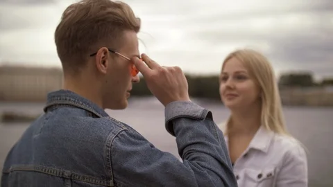 Charming young couple stylish guy and pretty girl chatting during romantic walk Video stock 114455757