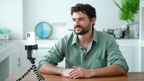 Charming young dark-haired bearded man, successful blogger vlogger, entrepreneur Stock Footage 218223728