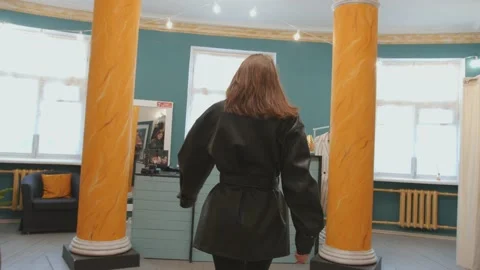 Charming young girl posing for the camera in an original outfit while shopping 库存影片 150445939