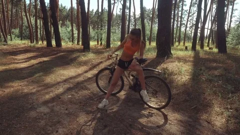 Charming young lady with a Bicycle Stock Footage