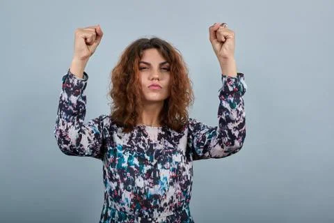 Charming young lady dancing, keeping fists up, pout lips , having nice ring 스톡 사진