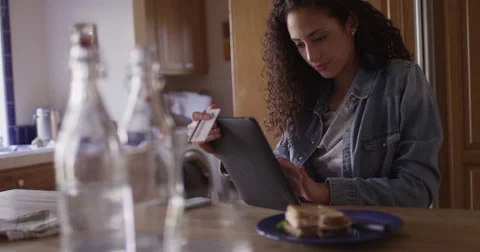 Charming young latino woman making online payment with a tablet Stock Footage