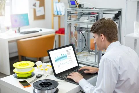 Charming young man creating a presentation on laptop Stock Photos