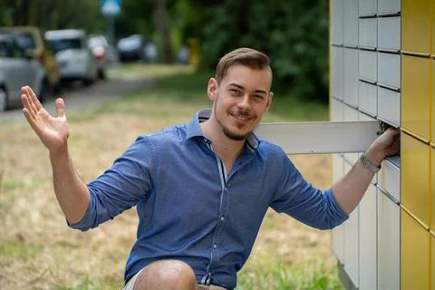 A Charming Young Man Joyfully Posing Outdoors in a Fun and Vibrant Natural 写真素材