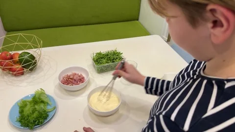 A charming young man is making creamy carbonara sauce Stock Footage 302927872