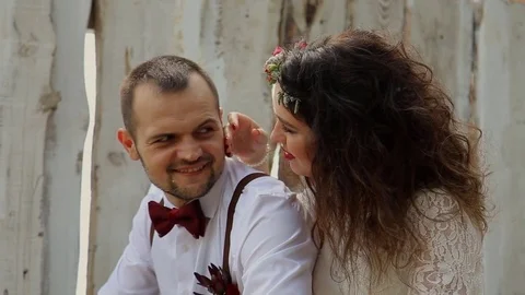 Charming young man smiling gorgeous young woman. On the background of old wooden Video stock 69888341