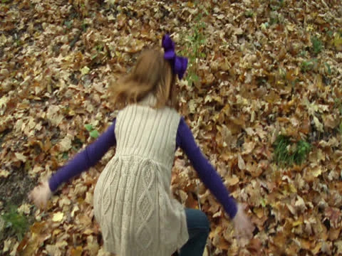 A charming young person throws the leaves Stock Footage 22863312