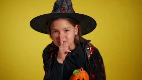 A charming young witch joyfully celebrating the fun and excitement of Halloween Stock Footage 315411699