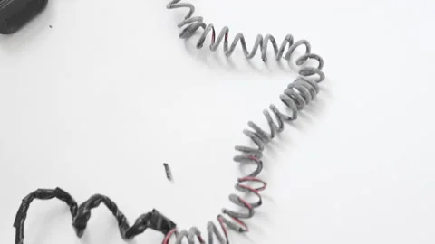 Charred charger wire, close-up. White background. Short-circuited concept Stock Footage 202283316