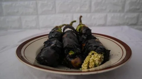 Charred eggplants on a plate, showcasing a rustic and smoky culinary preparat Foto stock