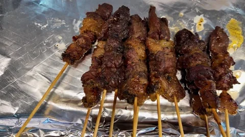 Charred Pork Skewers on Foil Thai Street Food BBQ Close Up 4K Video stock 333189341