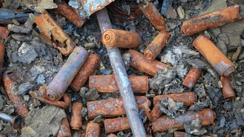 Charred spray cans after a fire in a store circular motion with smooth approach Stock Footage 196985735