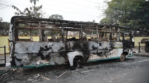 Charred vehicle which was reportedly set on fire by the protesters Video stock 122246154