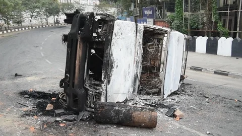 Charred vehicle which was reportedly set on fire by the protesters Video stock 122246172
