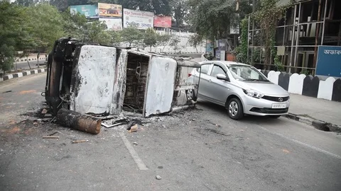 Charred vehicle which was reportedly set on fire by the protesters Video stock 122246244