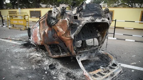Charred vehicle which was reportedly set on fire by the protesters Video stock 122246512