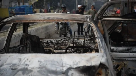 Charred vehicle which was reportedly set on fire by the protesters Video stock 122246515