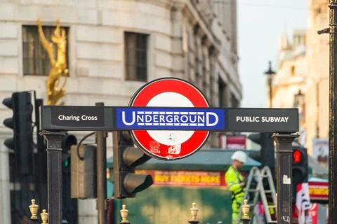 Charring cross London underground sign and a busy background in London, UK. Stock Photos