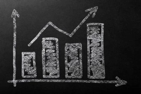 Chart up with bar in white chalk on a dark blackboard. Stock Photos