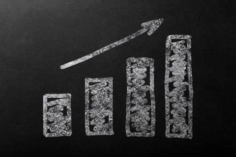 Chart up with bar in white chalk on a dark blackboard. Stock Photos