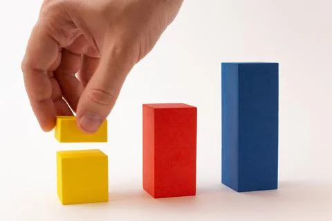 Chart from color blocks. Hand creates chart column. Stock Photos
