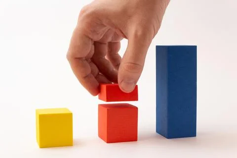 Chart from color blocks. Hand creates chart column. Stock Photos