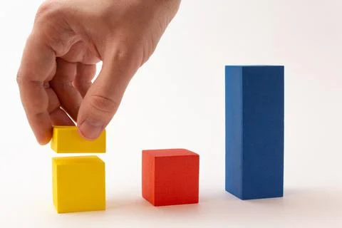 Chart from color blocks. Hand creates chart column. Stock Photos