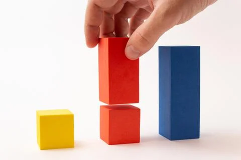 Chart from color blocks. Hand creates chart column. Stock Photos