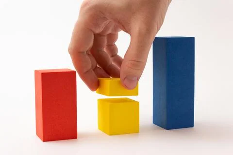 Chart from color blocks. Hand creates chart column. Stock Photos