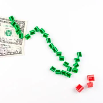 Chart pattern made of miniatur green houses is falling Stock Photos