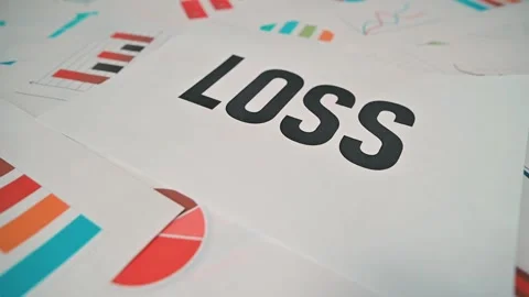 Charts and documents display graphs and data about financial loss in an office 库存影片 338188306