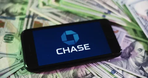 Chase Logo on iphone surrounded by $100 Bills. Chase Profits Layout. Stock Footage 169007666