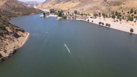 Chasing a boat in the Lake. 4K drone footage Stockbeeldmateriaal 136798459