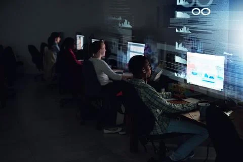 Chasing down their deadline. Rear view shot of a team of programmers coding t Stock-Fotos