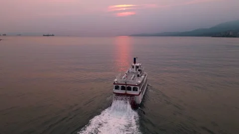 Chasing ferry boat into pink sunset 動画素材 248482600