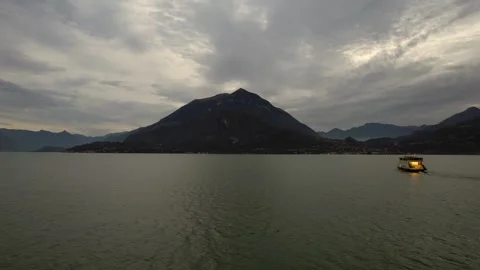 Chasing the Ferry boat: A Sunset Drone Pursuit Over Lake Comos Serene Waters Stock Footage 291172013