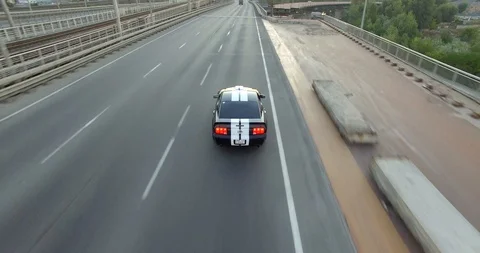 Chasing Ford Mustang on the bridge Stock Footage 91071136