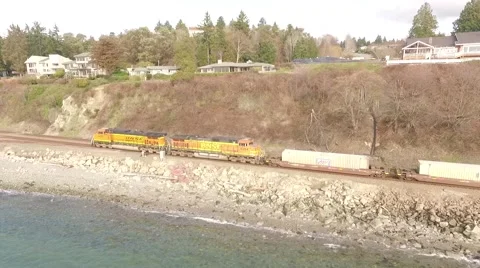 Chasing Freight Train on shoreline of Puget Sound Seattle Washington 1 Stock Footage 60114212