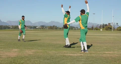 Chasing ground ball, diverse male teammates diving, throwing ball to tag out, Stock Footage 339650843
